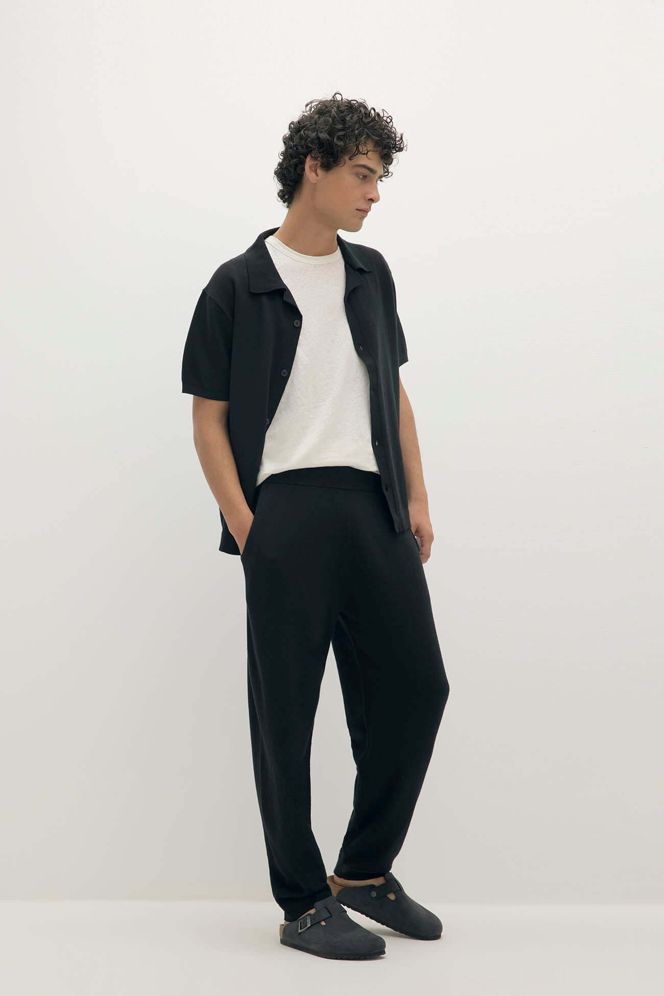 Stylish young man in black outfit exemplifying Men Wear fashion collection.